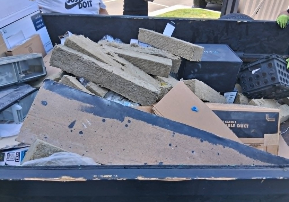 Real We Haul It trailer loaded with construction debris