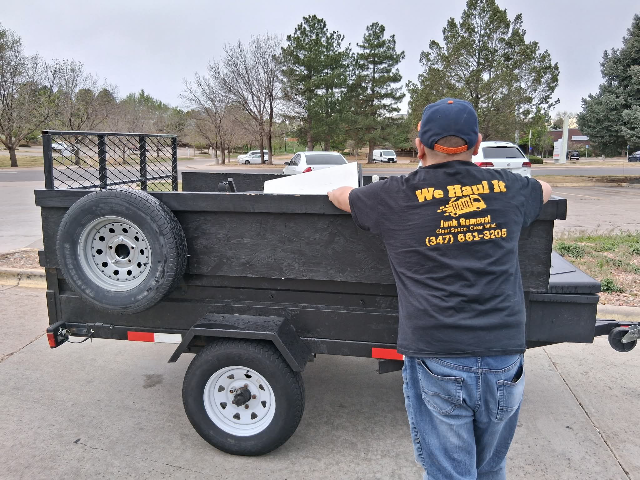 We Haul It crew shirt at a job site